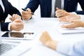 Group of business people and lawyers discussing contract papers sitting at the table, close-up. Successful teamwork