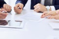 Group of business people and lawyers discussing contract papers sitting at the table, close-up. Successful teamwork Royalty Free Stock Photo