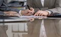 Group of business people and lawyers discussing contract while sitting at the table. Woman chief is taking pen for Royalty Free Stock Photo