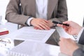 Group of business people and lawyers discussing contract sitting at the table. Woman chief is taking pen for signing Royalty Free Stock Photo