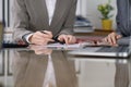 Group of business people and lawyers discussing contract while sitting at the table. Woman chief is taking pen for Royalty Free Stock Photo