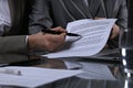 Group of business people and lawyers discussing contract sitting at the table. Woman chief is taking pen for signing Royalty Free Stock Photo