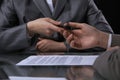 Group of business people and lawyers discussing contract sitting at the table. Woman chief is taking pen for signing Royalty Free Stock Photo