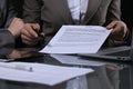 Group of business people and lawyers discussing contract sitting at the table. Woman chief is taking pen for signing Royalty Free Stock Photo