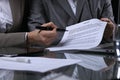 Group of business people and lawyers discussing contract sitting at the table. Woman chief is taking pen for signing Royalty Free Stock Photo