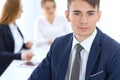 Group of business people or lawyers discussing terms of transaction in office. Focus at young businessman. Meeting and Royalty Free Stock Photo