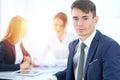 Group of business people or lawyers discussing terms of transaction in office. Focus at young businessman. Meeting and Royalty Free Stock Photo