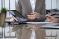 Group of business people or lawyers at meeting discussing contract papers. Woman pointing into touch pad compute Royalty Free Stock Photo