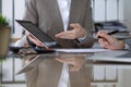 Group of business people or lawyers at meeting discussing contract papers. Woman pointing into touch pad compute Royalty Free Stock Photo