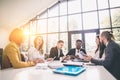 Group Of Business People Listening To Colleague Addressing Office Meeting Royalty Free Stock Photo