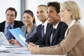 Group Of Business People Listening To Colleague Addressing Office Meeting Royalty Free Stock Photo