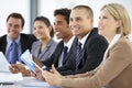 Group Of Business People Listening To Colleague Addressing Office Meeting Royalty Free Stock Photo