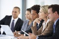 Group Of Business People Listening To Colleague Addressing Office Meeting Royalty Free Stock Photo