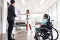 Group of business people in a meeting with colleague, disabled working woman on wheelchair Royalty Free Stock Photo