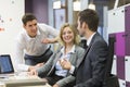 Group of business people in a meeting at office, working on comp