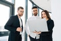 Group of business people in the office looking in laptop. Secretary shows report to bosses. Royalty Free Stock Photo