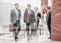 Group of business people passing through the lobby of the business center Royalty Free Stock Photo