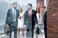 Group of business people passing through the lobby of the business center Royalty Free Stock Photo