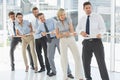 Group of business people pulling rope in office Royalty Free Stock Photo