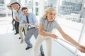 Group of business people pulling rope in office Royalty Free Stock Photo