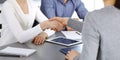 Group of business people shaking hands after discussing questions at meeting in modern office. Handshake close-up Royalty Free Stock Photo