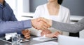 Group of business people shaking hands after discussing questions at meeting in modern office. Handshake close-up Royalty Free Stock Photo