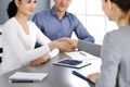 Group of business people shaking hands after discussing questions at meeting in modern office. Handshake close-up Royalty Free Stock Photo