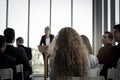 Group of business people sitting on conference together listening to the speaker giving a speech in the meeting room seminar  The Royalty Free Stock Photo