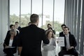 Group of business people sitting on conference together listening to the speaker giving a speech in the meeting room seminar The Royalty Free Stock Photo