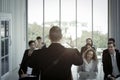 Group of business people sitting on conference together listening to the speaker giving a speech in the meeting room seminar The Royalty Free Stock Photo