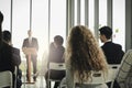 Group of business people sitting on conference together listening to the speaker giving a speech in the meeting room seminar Royalty Free Stock Photo