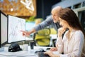 Group of business people sitting and standing together at the office surrounded computers and working together Royalty Free Stock Photo