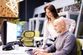 Group of business people sitting and standing together at the office surrounded computers and working together Royalty Free Stock Photo