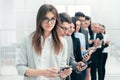 Group of business people with smartphones standing in a row Royalty Free Stock Photo