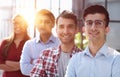 group of business people smiling in an office lined up Royalty Free Stock Photo