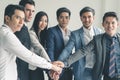 Group of business people stacking hands together showing power of teamwork Royalty Free Stock Photo