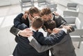 group of business people standing in a close circle.