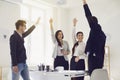 Group of business people standing smiling raised their hands up happy standing at a table in the office. Royalty Free Stock Photo