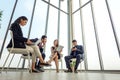 Group of multi ethnic busy people working in an office,  businessman and businesswoman sitting in conference room with blank copy Royalty Free Stock Photo