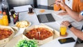 Group of business people talking about project and prepare pizza and potato chips for having lunch in corporate together in office Royalty Free Stock Photo