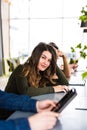 Group of business people using digital devices. Team of people working at their table in devices in modern office. Beauty girl loo Royalty Free Stock Photo