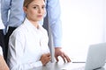 Group of business people using laptop computer while standing in office. Meeting and teamwork concept Royalty Free Stock Photo