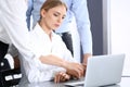 Group of business people using laptop computer while standing in office. Meeting and teamwork concept Royalty Free Stock Photo