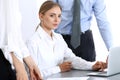 Group of business people using laptop computer while standing in office. Meeting and teamwork concept Royalty Free Stock Photo