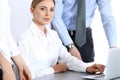 Group of business people using laptop computer while standing in office. Meeting and teamwork concept Royalty Free Stock Photo