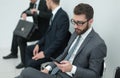 Group of business people waiting for a meeting sitting in the office reception. Royalty Free Stock Photo