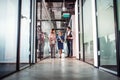 Group of business people walking in an office building, talking. Royalty Free Stock Photo