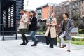 Group of business people walking outside in front of office building. Colleagues discussing on the way to the work. Young Royalty Free Stock Photo