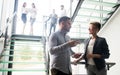 Group of business people walking and taking at stairs in an office Royalty Free Stock Photo