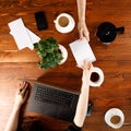 Group of business people working at desk, top view. Weekday work concept. Office stuff and gadgets nearby.Square Royalty Free Stock Photo